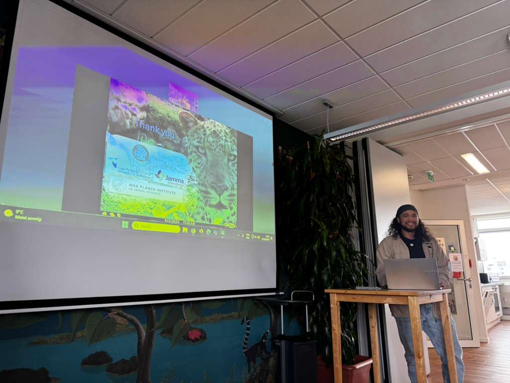 Joshua presenting his ARTEMIS research project at the programme's final symposium